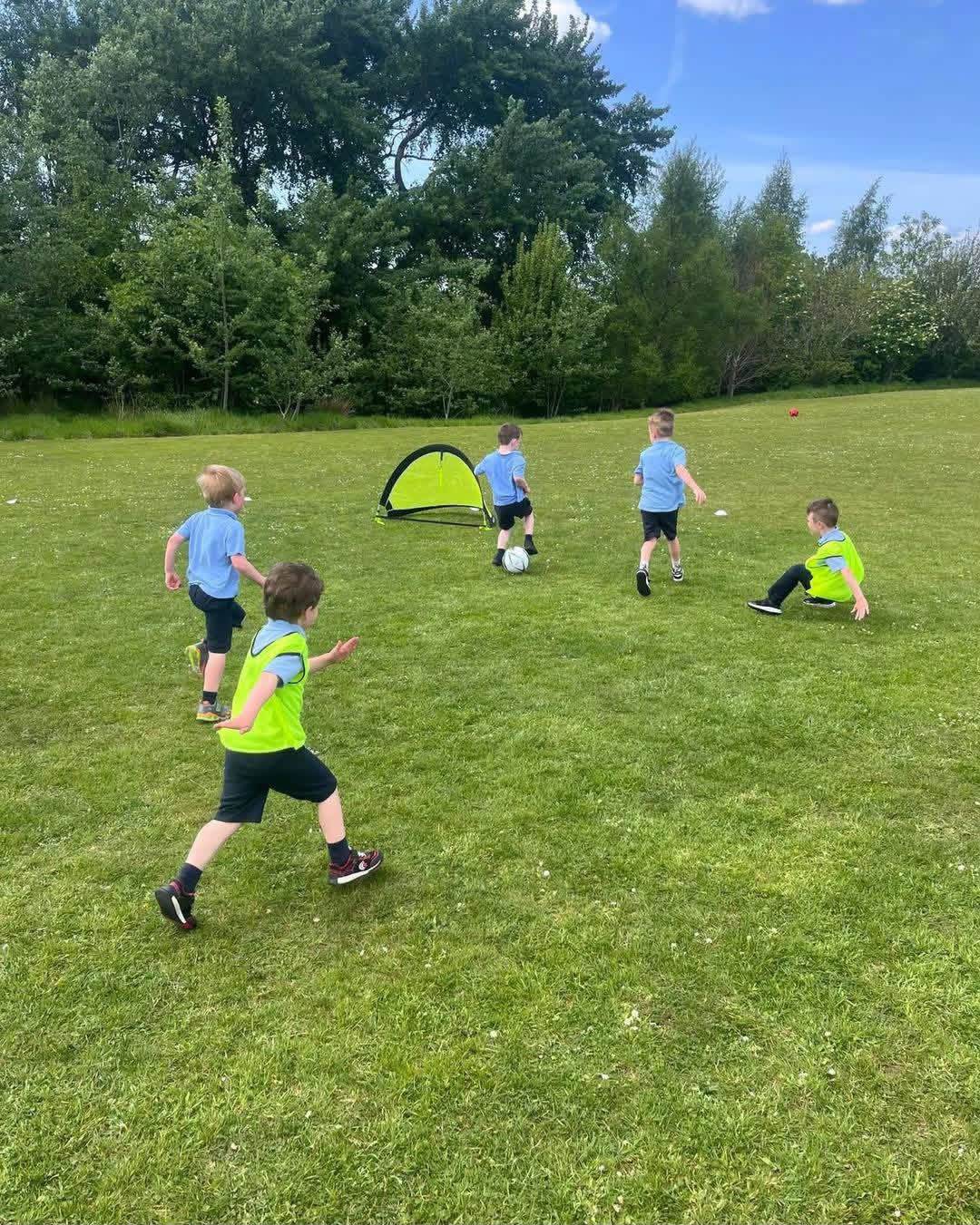 Children playing football with a pop-up goal during an Elevate Sports Sports Party