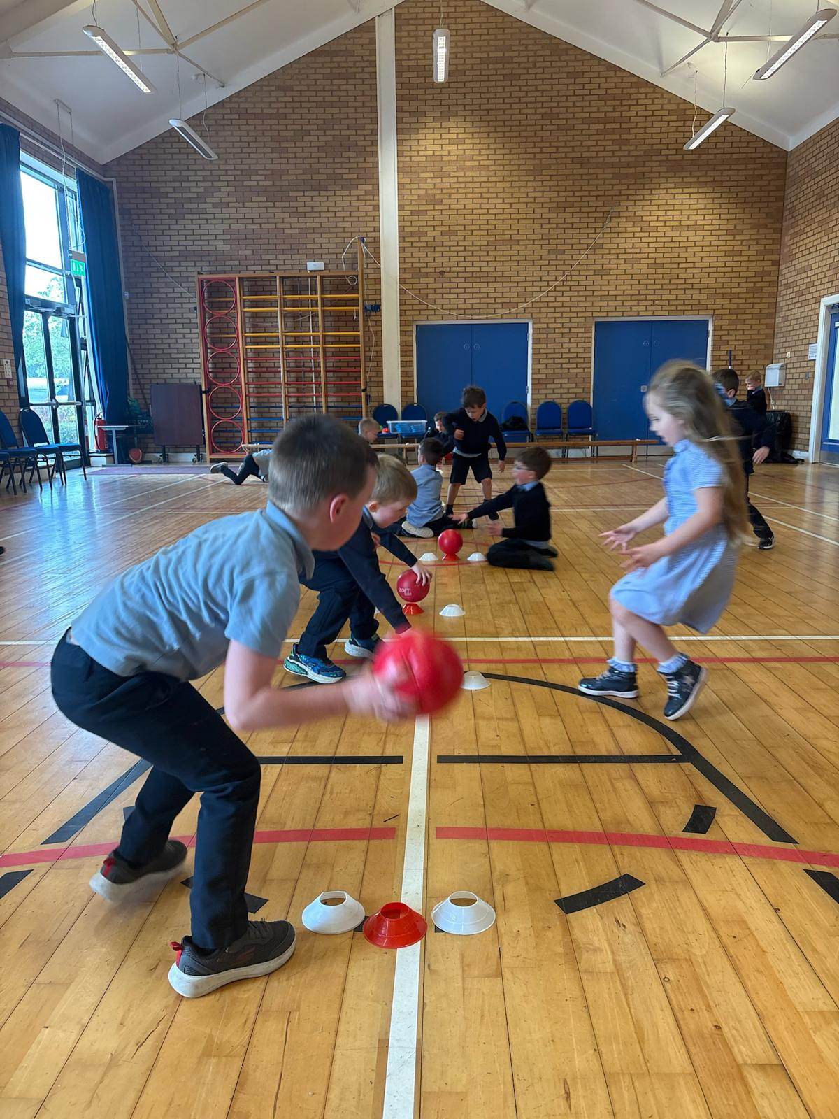 A mixed group of children playing dodgeball together during a Shared Education session