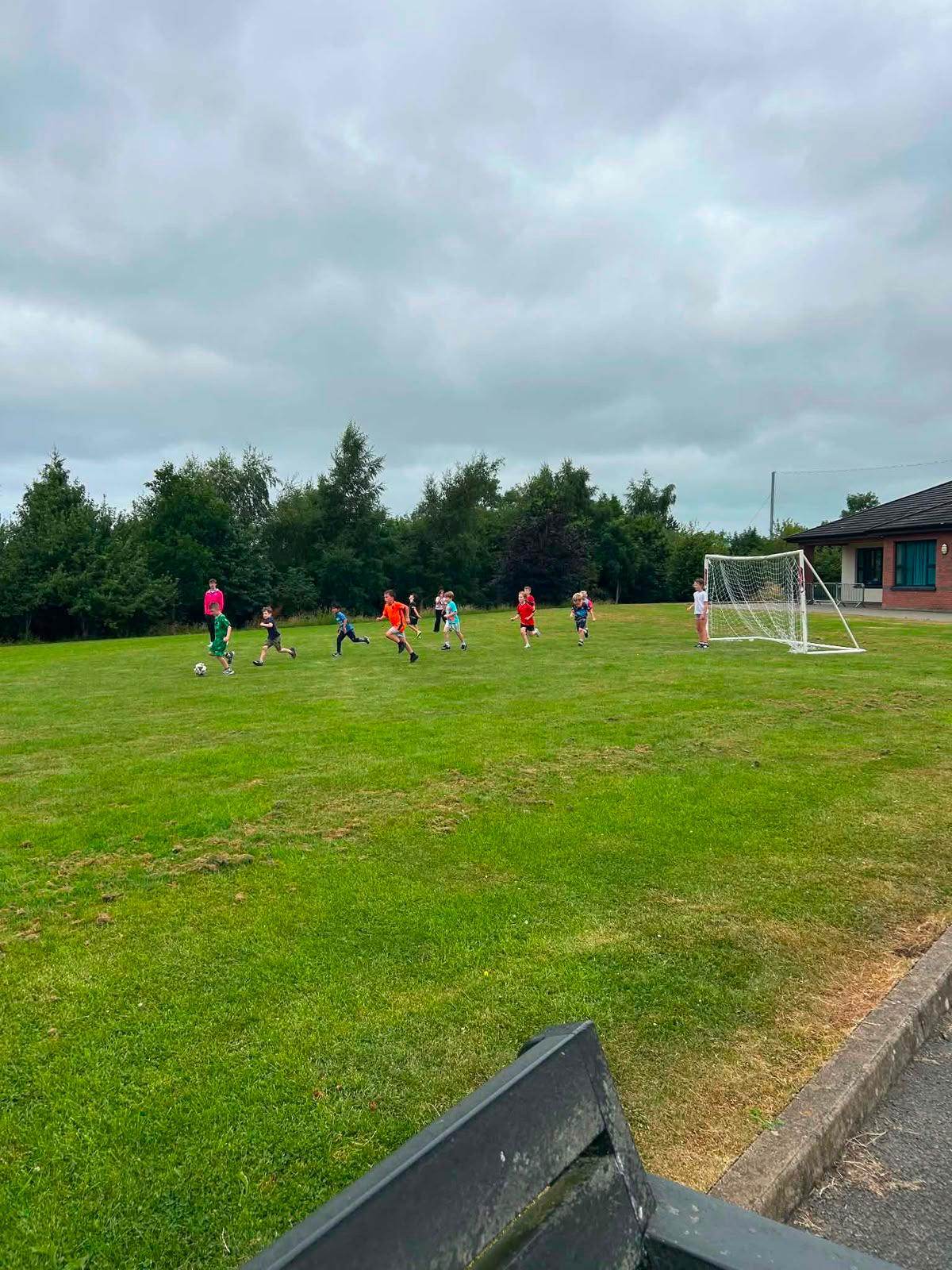 Children playing football outdoors during an Elevate Sports PE session