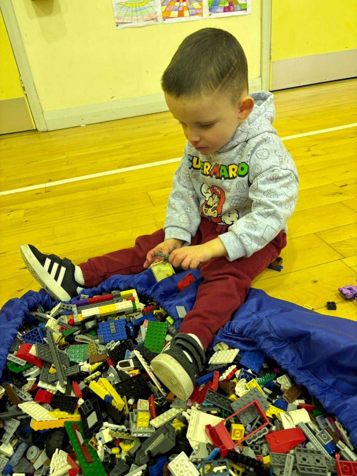 Child building with LEGO bricks during a birthday party